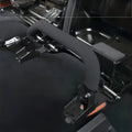 Close-up view of a single black quick-release seat bracket with a foam-covered handle installed on the vehicle floor.