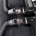Close-up of the quick-release bracket hardware and mounting pins installed on a vehicle's rear seat structure.
