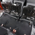 Wide-angle interior view showing quick-release brackets installed with rear seats folded forward for maximum storage.