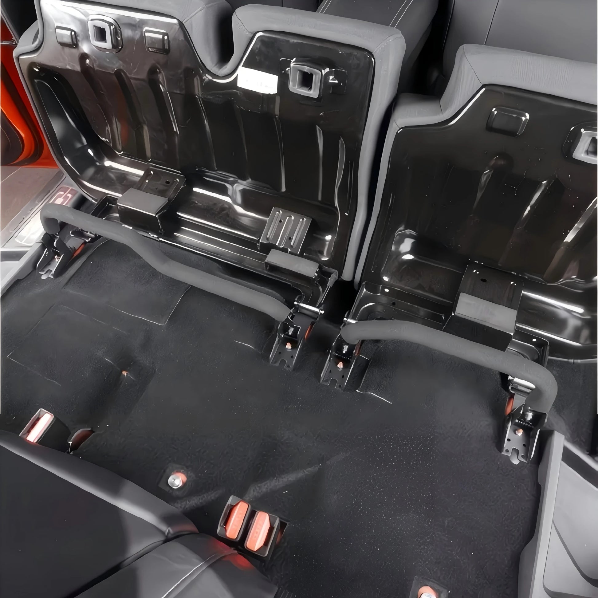 Wide-angle interior view showing quick-release brackets installed with rear seats folded forward for maximum storage.