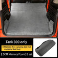 Tank 300 non-inflatable 5cm memory foam camping bed mat shown laid out in a vehicle trunk and rolled in its storage bag.